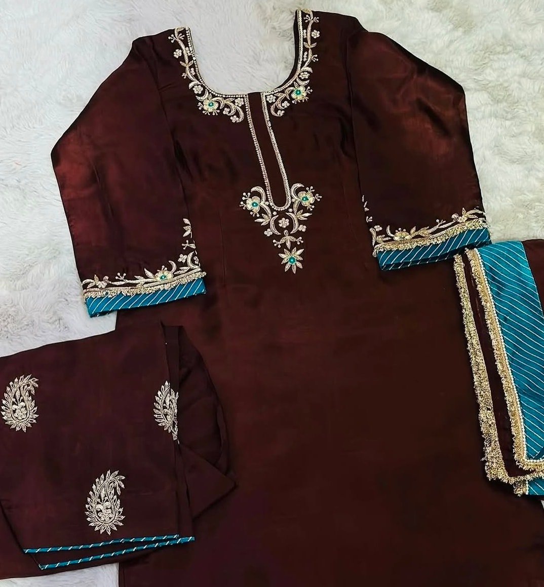 Artisan hand-embroidering an ethnic suit at V.K Fashion Boutique
